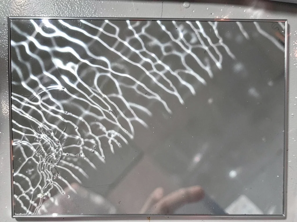 Silver mirror showing rippled image