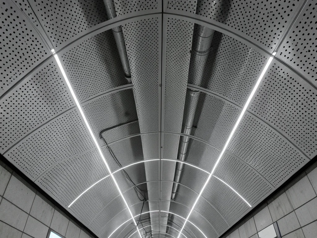 The ceiling of a modern Dubai metro station, a sweeping parametric surface of pe
