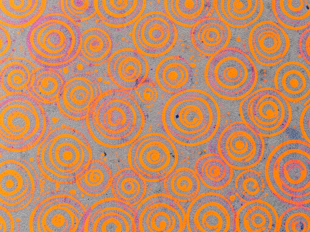 Dense all-over risograph pattern of concentric circles in fluorescent orange on 