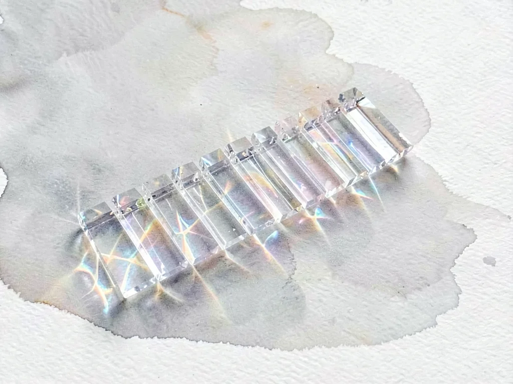Refracted ice-clear lowpoly xylophone with a row of transparent bars catching cr