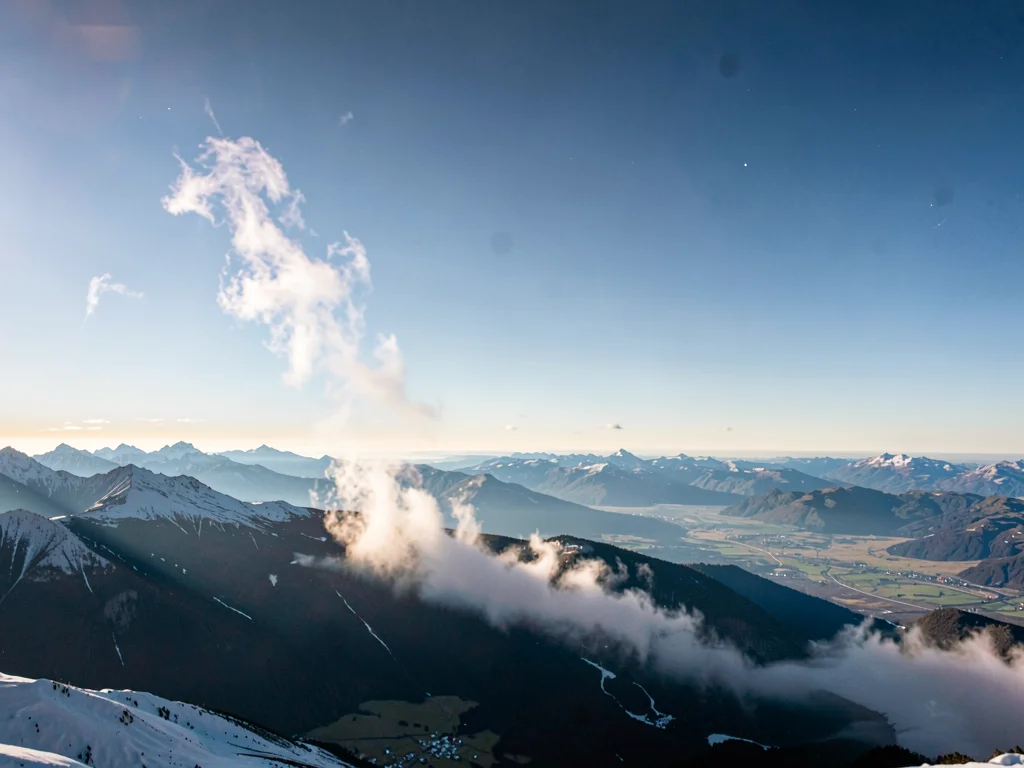Frost smoke rising from valley into thin clear atmosphere