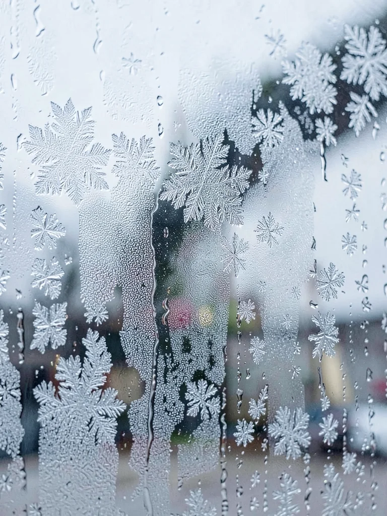 Morning frost on window glass looking crystalline and cold